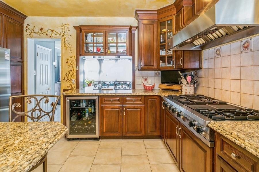 156 80th Street Brooklyn, NY 11209 - Photo 13 of 37 a kitchen with stainless steel appliances granite countertop a stove and cabinets