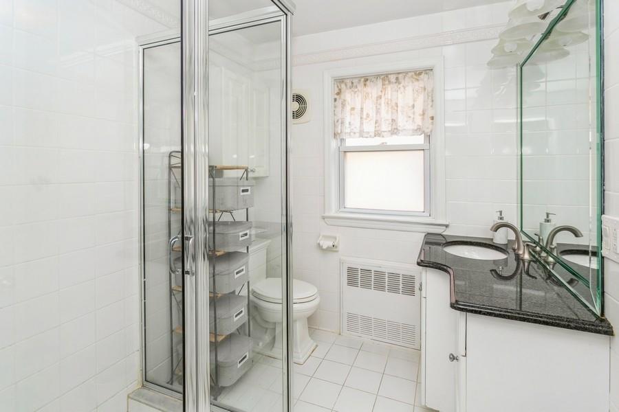 156 80th Street Brooklyn, NY 11209 - Photo 24 of 37 a bathroom with a granite countertop sink a toilet and shower