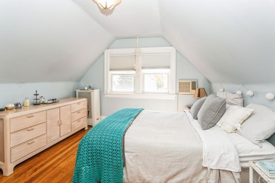 156 80th Street Brooklyn, NY 11209 - Photo 26 of 37 a bedroom with a large bed and a window