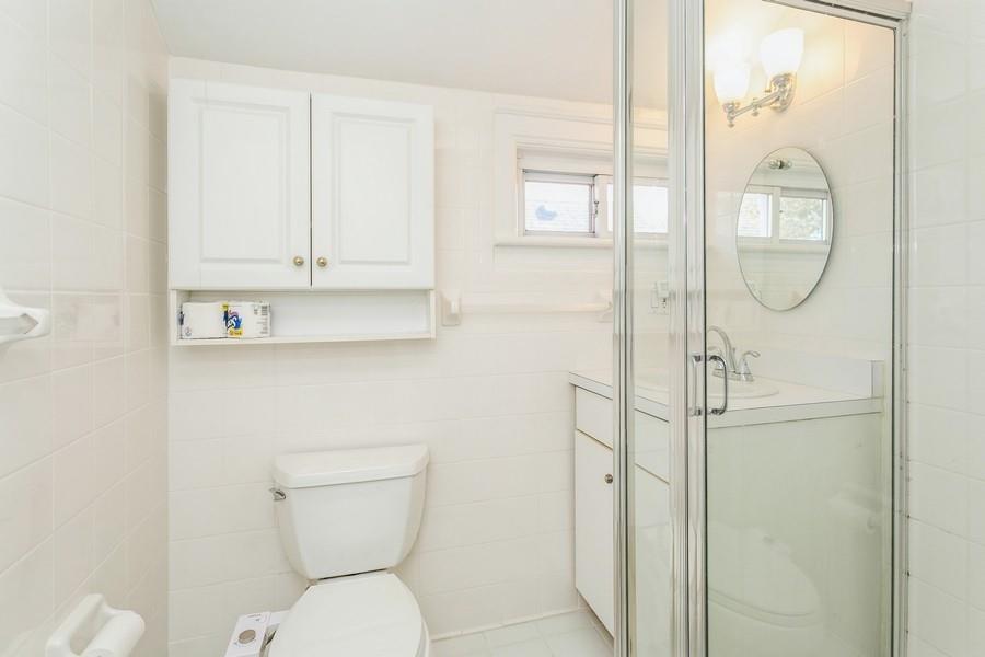 156 80th Street Brooklyn, NY 11209 - Photo 27 of 37 a bathroom with a toilet a sink and mirror