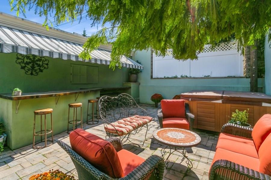 156 80th Street Brooklyn, NY 11209 - Photo 30 of 37 a patio with table and chairs with potted plants
