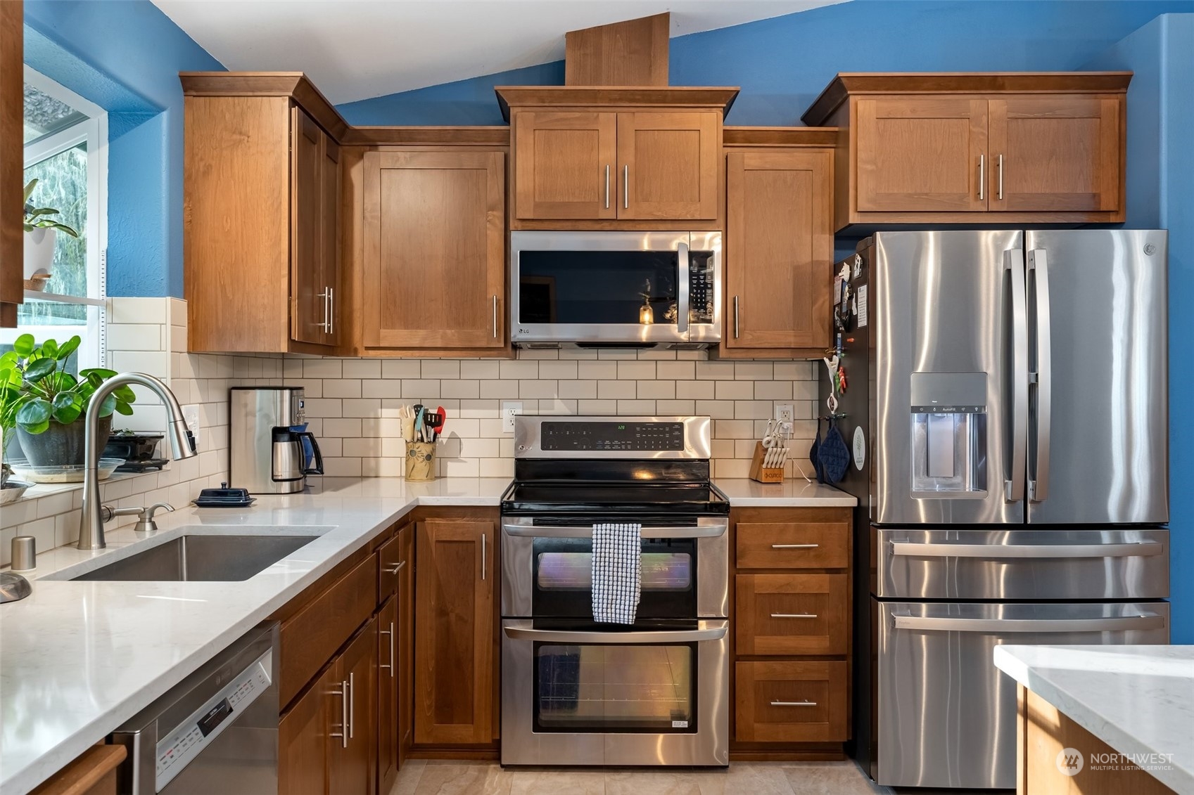 688 Evans Road Toledo, WA 98591 - Photo 11 of 40 a kitchen with granite countertop a refrigerator and a sink