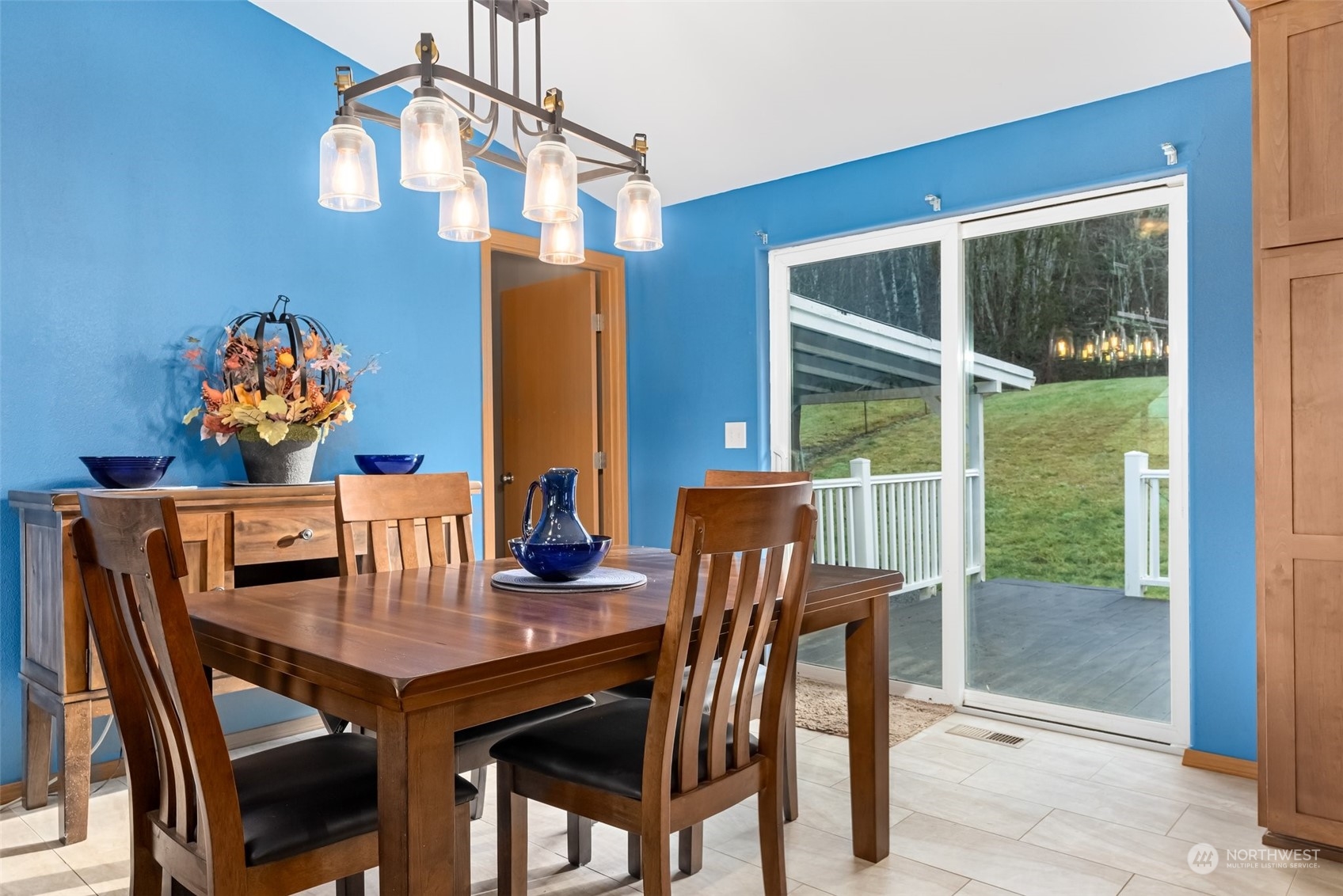 688 Evans Road Toledo, WA 98591 - Photo 13 of 40 a view of a dining room with furniture a chandelier and wooden floor