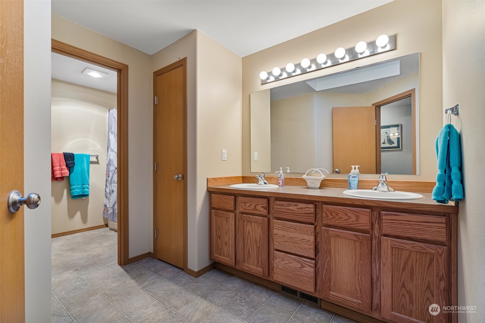 688 Evans Road Toledo, WA 98591 - Photo 24 of 40 a spacious bathroom with a double vanity sink and a mirror