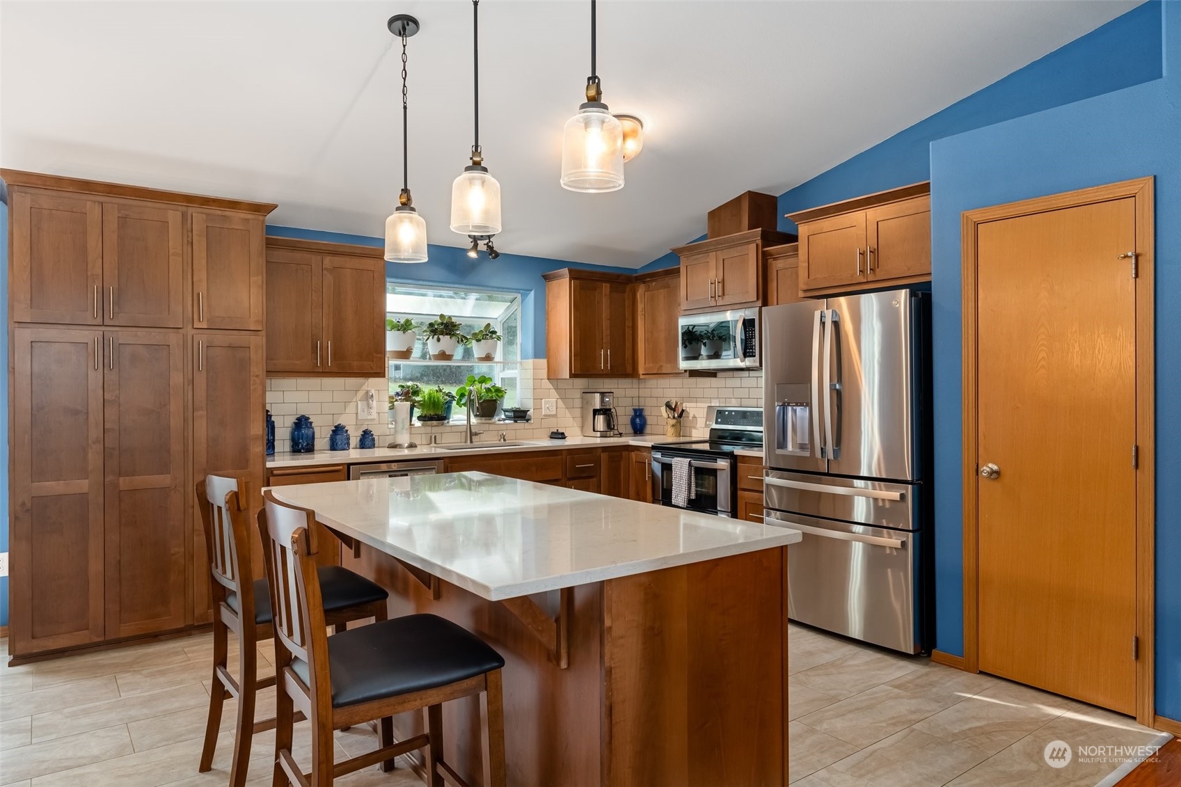 688 Evans Road Toledo, WA 98591 - Photo 9 of 40 a kitchen with granite countertop a refrigerator a stove a sink dishwasher a kitchen island with wooden cabinets and stainless steel appliances