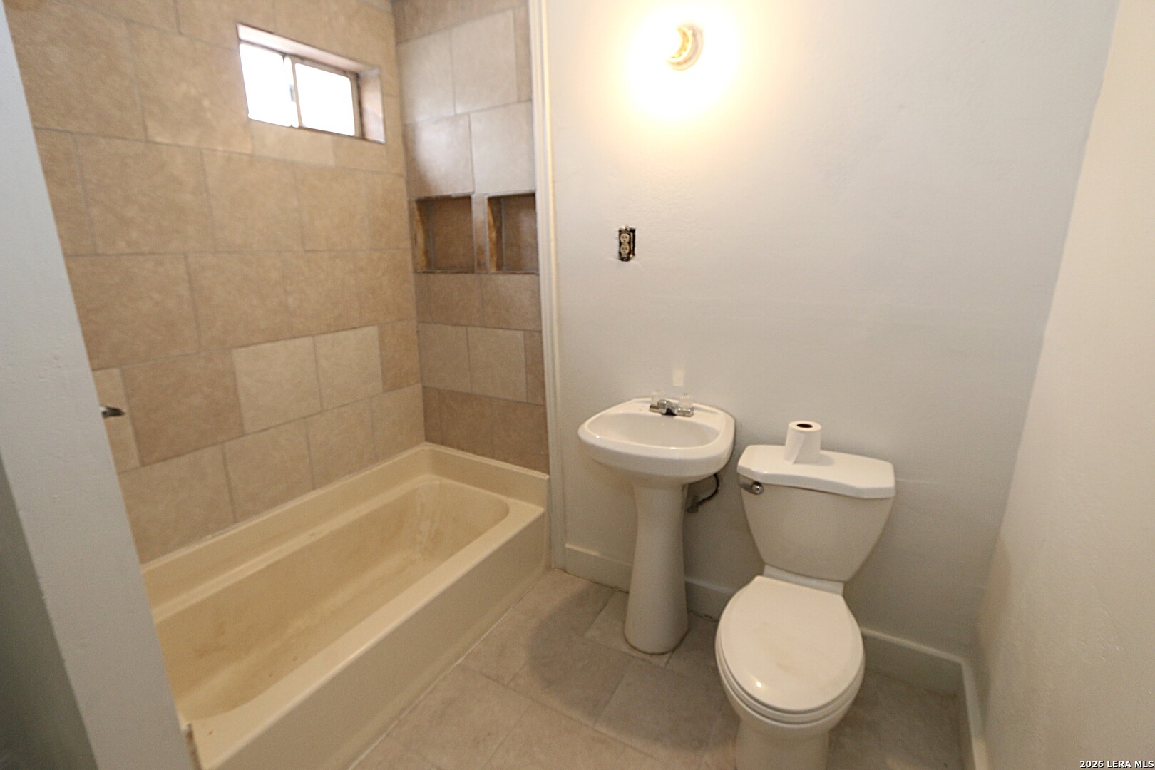 910 Culebra Road San Antonio, TX 78201 - Photo 11 of 33 a white toilet sitting next to a bath tub