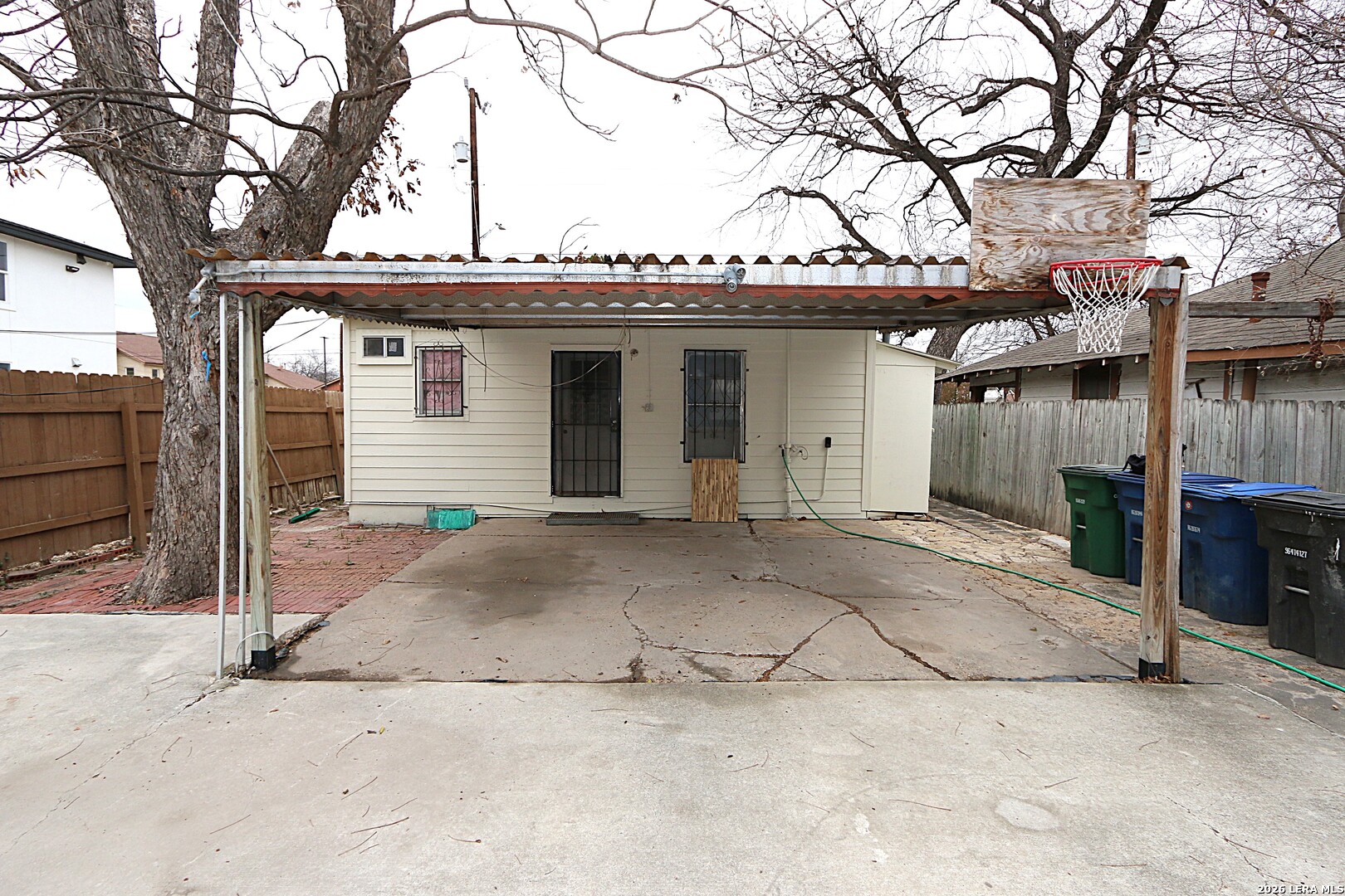 910 Culebra Road San Antonio, TX 78201 - Photo 16 of 33 a view of a white house with a large tree and a yard