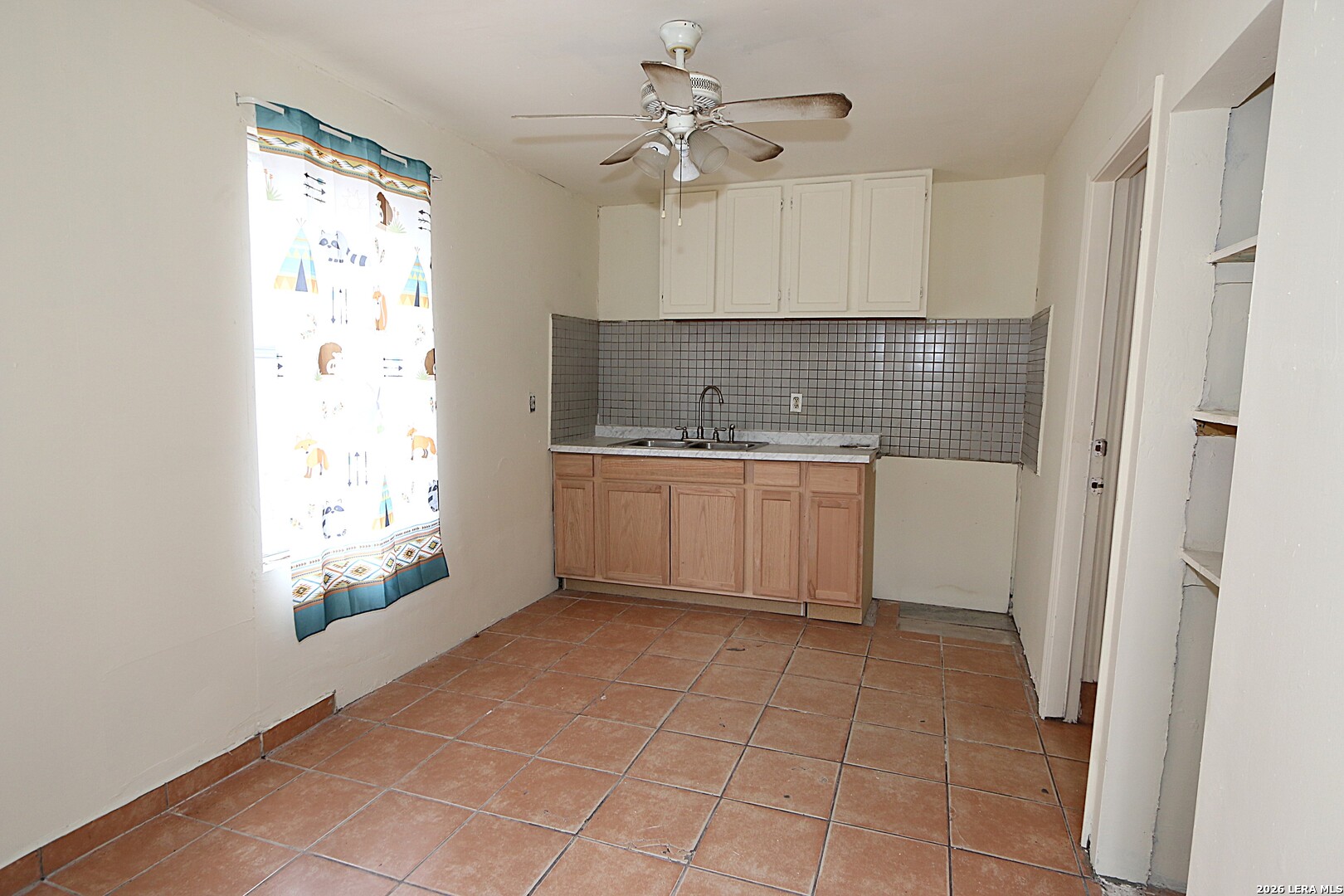 910 Culebra Road San Antonio, TX 78201 - Photo 21 of 33 a kitchen with a sink a refrigerator and window