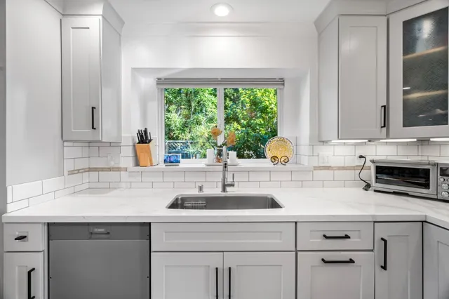 a kitchen with appliances cabinets and a window