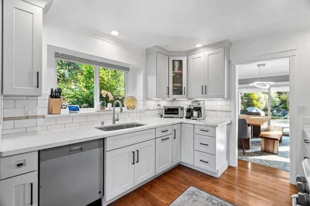 a kitchen with sink cabinets and wooden floor