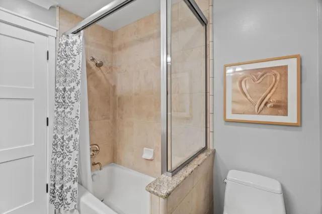 a bathroom with a bathtub and shower