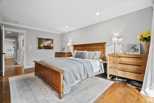 a bedroom with a bed and painting on the wall