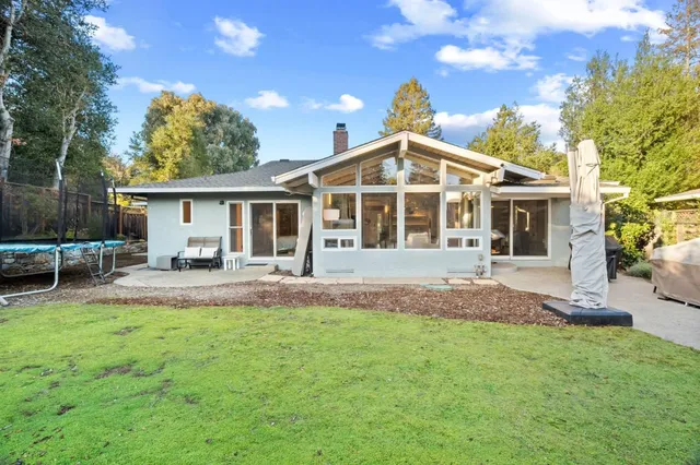 a front view of a house with a yard and porch