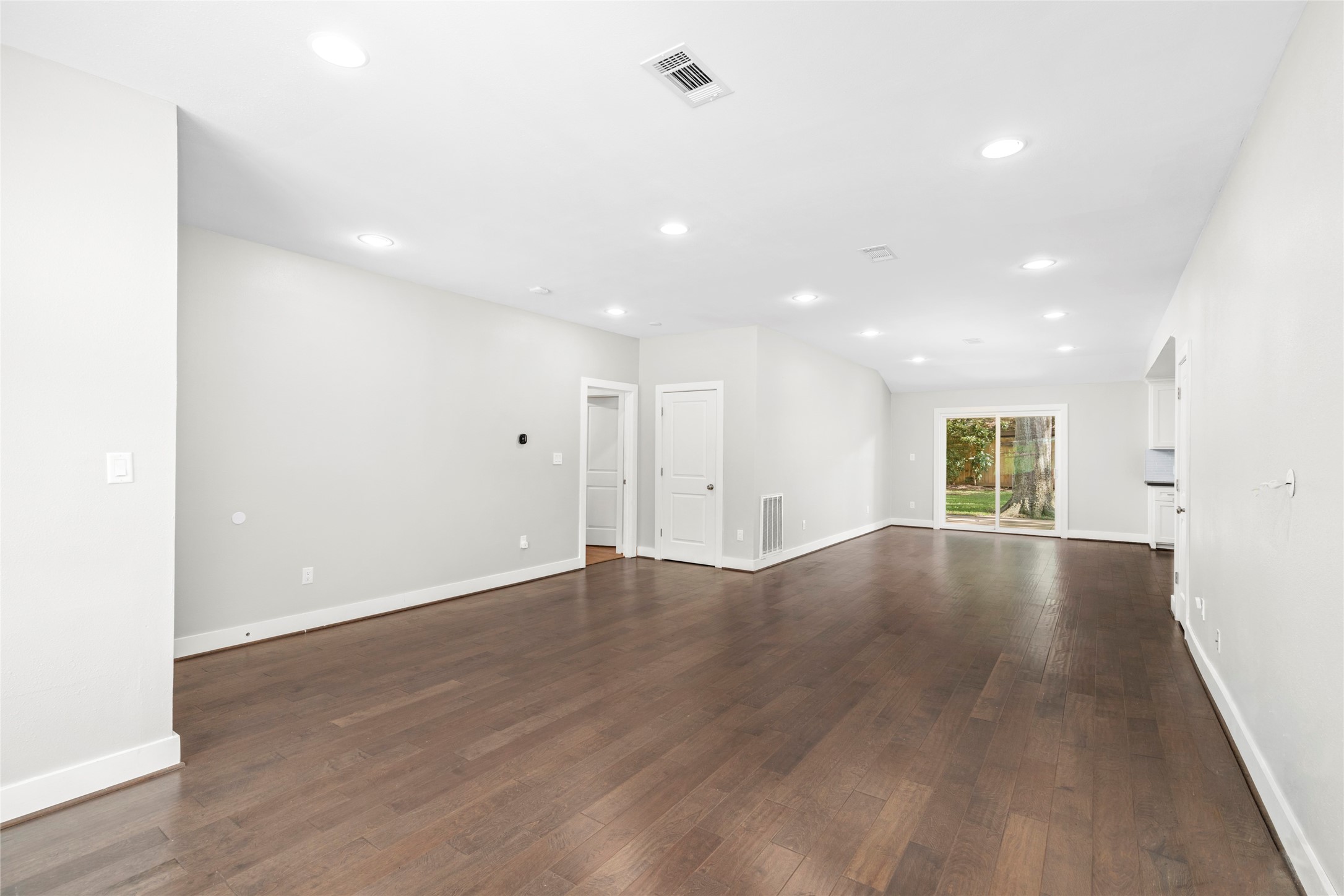 5723 Spellman Road Houston, TX 77096 - Photo 4 of 29 The living room has engineered hardwood flooring, recessed lighting, and plenty of natural light from the large front window.