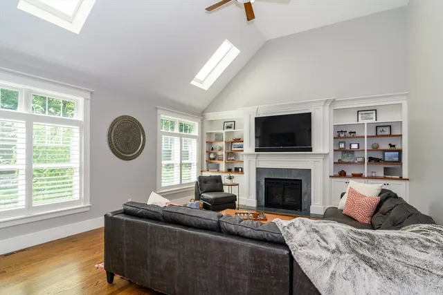 a living room with furniture flat screen tv and a fireplace