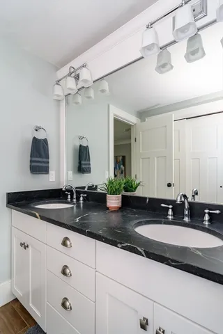 a bathroom with double sink and a mirror