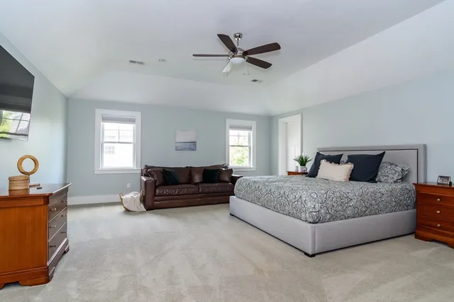 a living room with a bed window and a flat screen tv