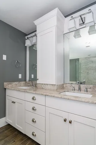 a bathroom with a granite countertop sink mirror and double