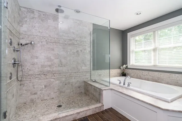 a bathroom with a bathtub and a shower