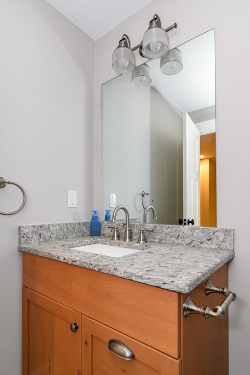 15 Hunters Lane Natick, MA 01760 - Photo 32 of 42 a bathroom with a granite countertop sink and a mirror