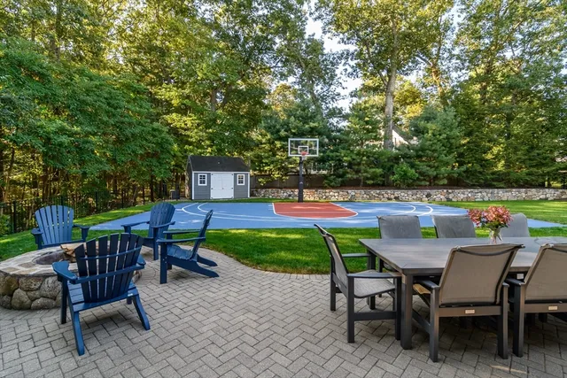 a view of a chairs and table in backyard