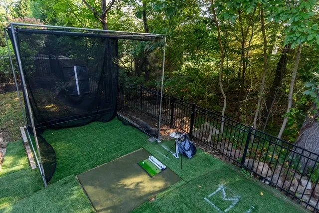 a view of a backyard with couches plants and large tree