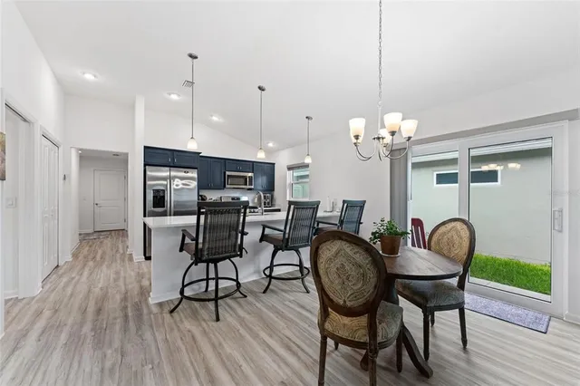 a kitchen with stainless steel appliances kitchen island a large island in the center and wooden floor