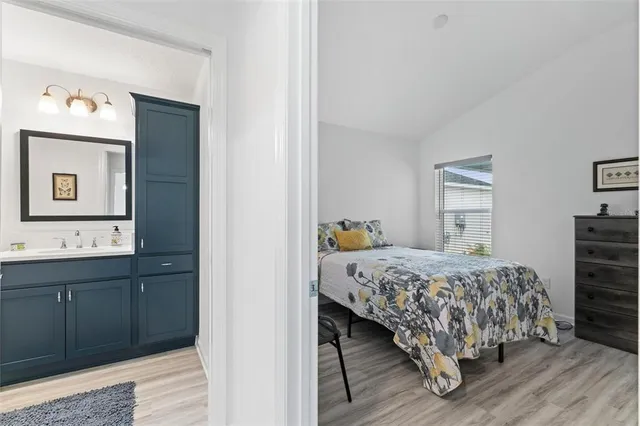 a view of a kitchen with a stove wooden cabinets and wooden floor