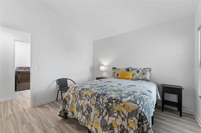 a view of a workspace with furniture and wooden floor