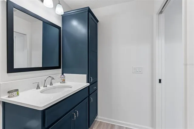 a view of a chair and table in backyard of the house