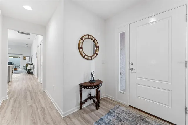 a living room with furniture kitchen view and a window