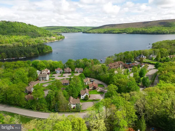 an aerial view of residential house with outdoor space and lake view