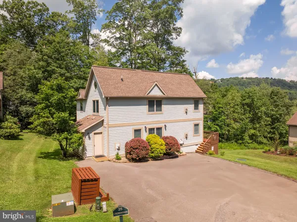 a aerial view of a house with yard
