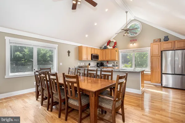 a dining room with furniture and wooden floor