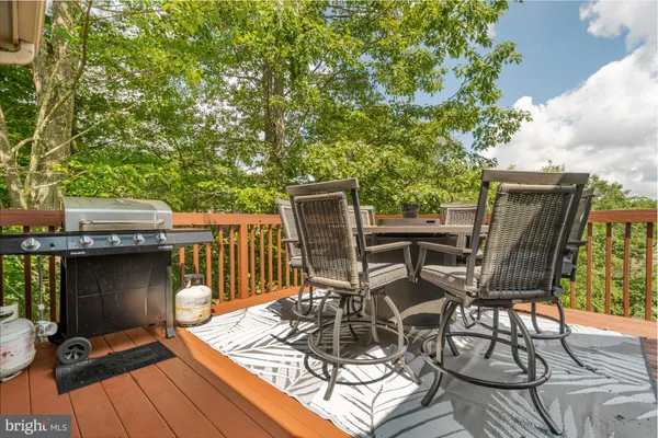 a view of a chairs and table on the deck