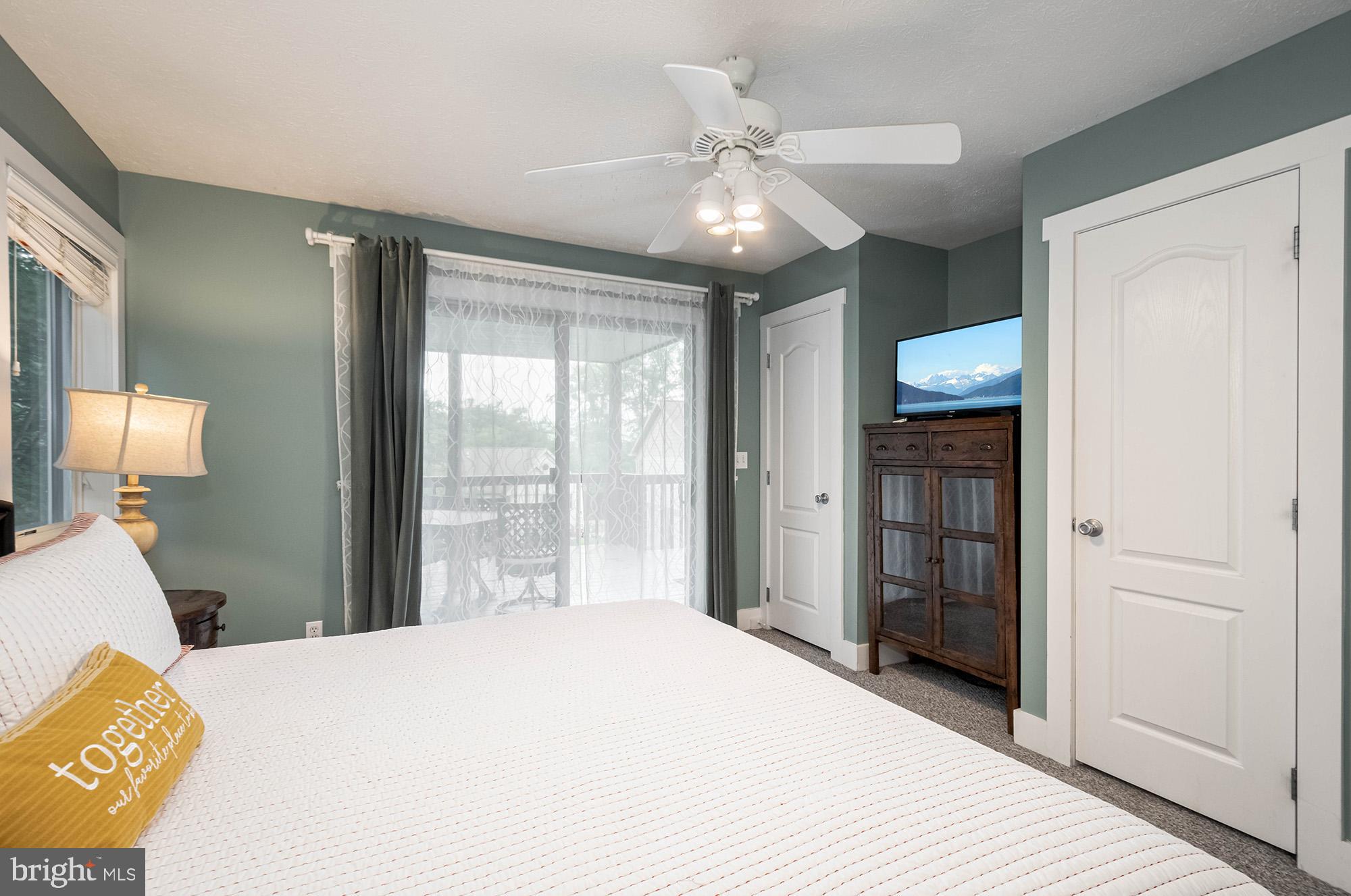 25 Silver Tree Lane Oakland, MD 21550 - Photo 46 of 52 a bedroom with a bed and a chandelier