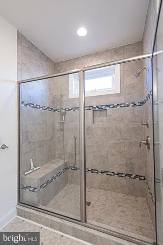 a bathroom with a granite countertop sink a toilet and a mirror