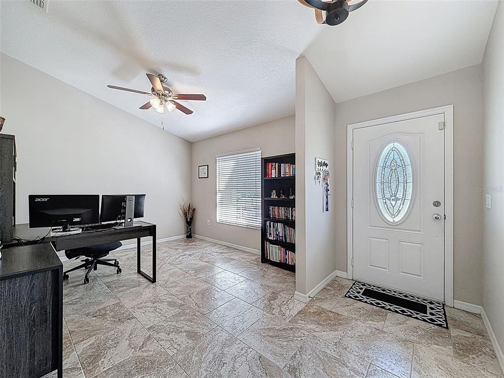 12105 Maripoe Road Weeki Wachee, FL 34614 - Photo 11 of 62 a view of workspace with lounge chair and windows