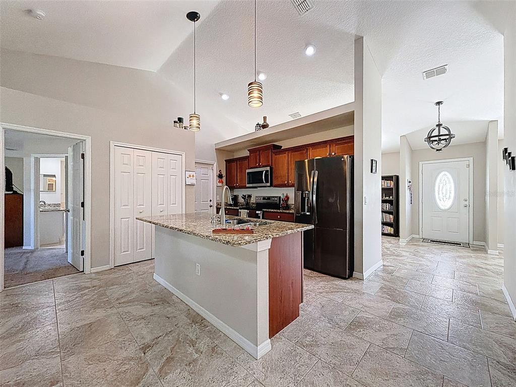 12105 Maripoe Road Weeki Wachee, FL 34614 - Photo 13 of 62 a large kitchen with stainless steel appliances granite countertop a refrigerator a oven and a sink