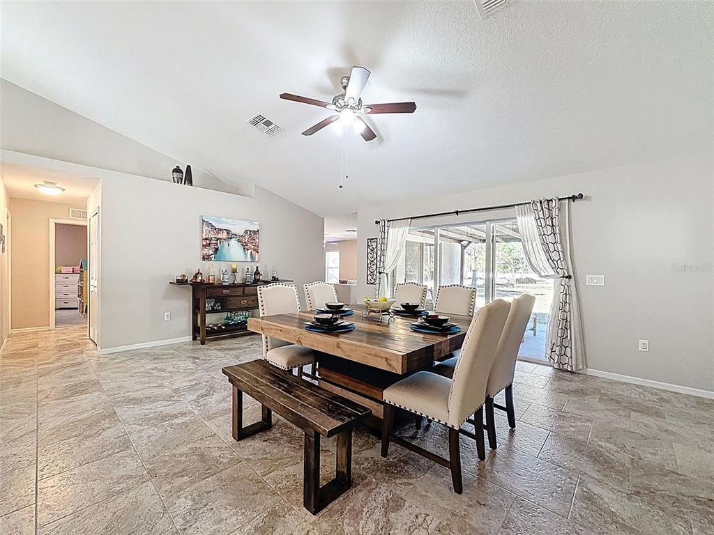 12105 Maripoe Road Weeki Wachee, FL 34614 - Photo 23 of 62 a dining room with furniture and window