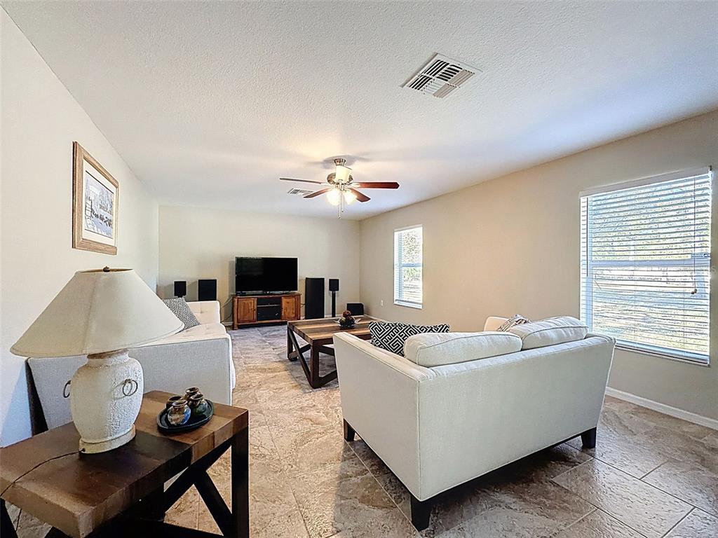 12105 Maripoe Road Weeki Wachee, FL 34614 - Photo 24 of 62 a living room with furniture and a flat screen tv