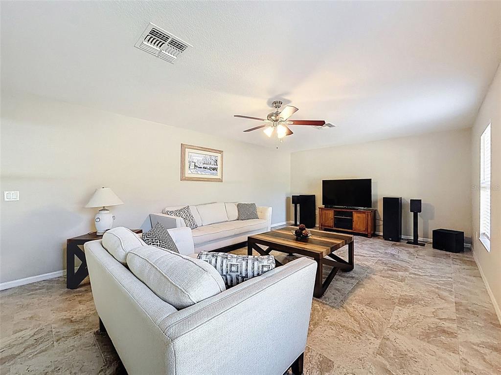 12105 Maripoe Road Weeki Wachee, FL 34614 - Photo 26 of 62 a living room with furniture and a flat screen tv