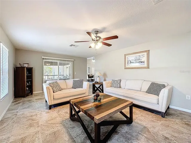 a bedroom with furniture and a fan