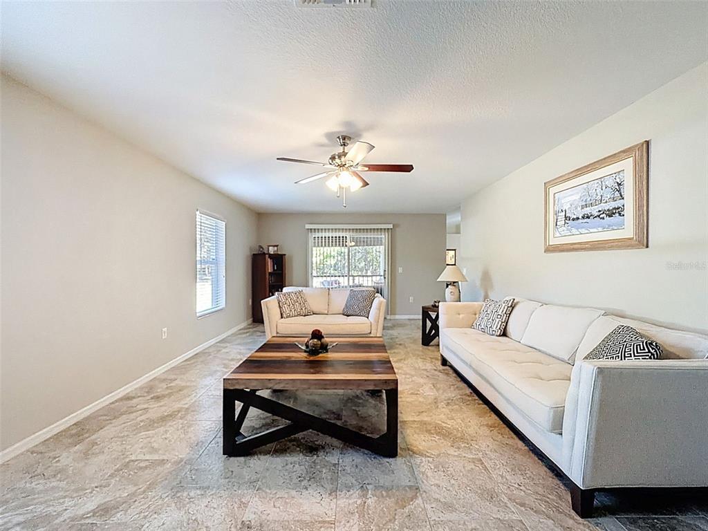 12105 Maripoe Road Weeki Wachee, FL 34614 - Photo 28 of 62 a living room with furniture and a potted plant