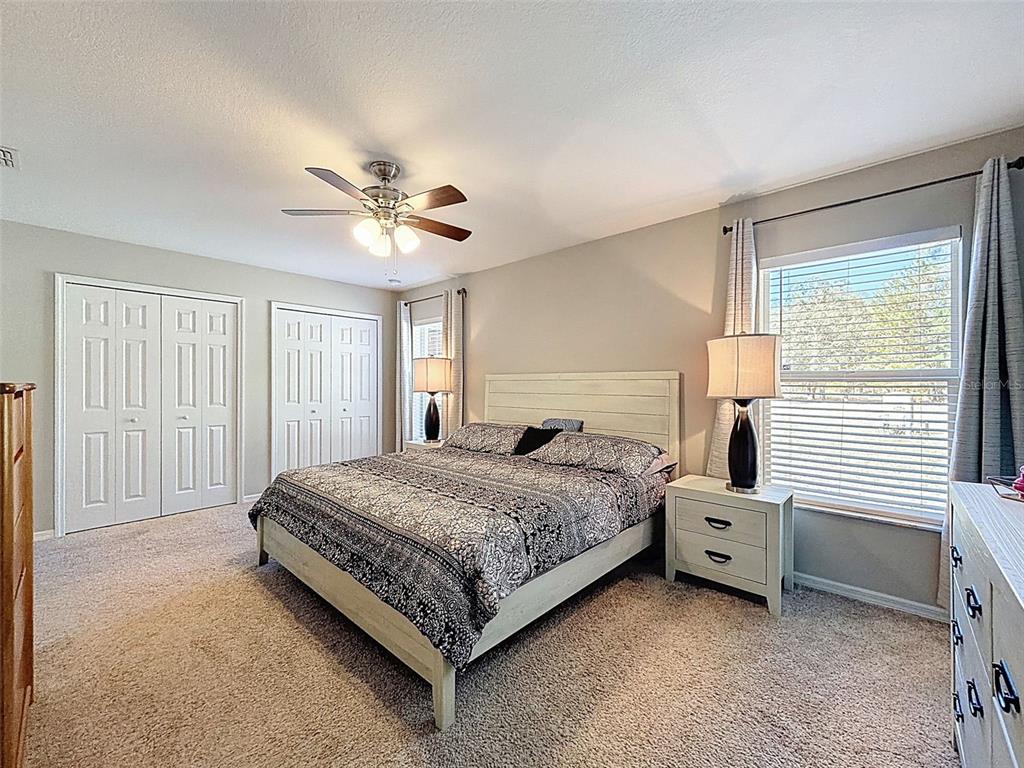 12105 Maripoe Road Weeki Wachee, FL 34614 - Photo 29 of 62 a bedroom with a bed and a ceiling fan