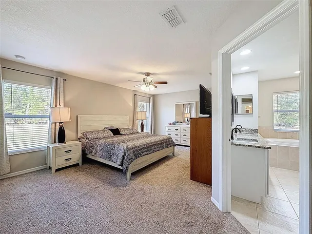 a bedroom with bed and a chandelier