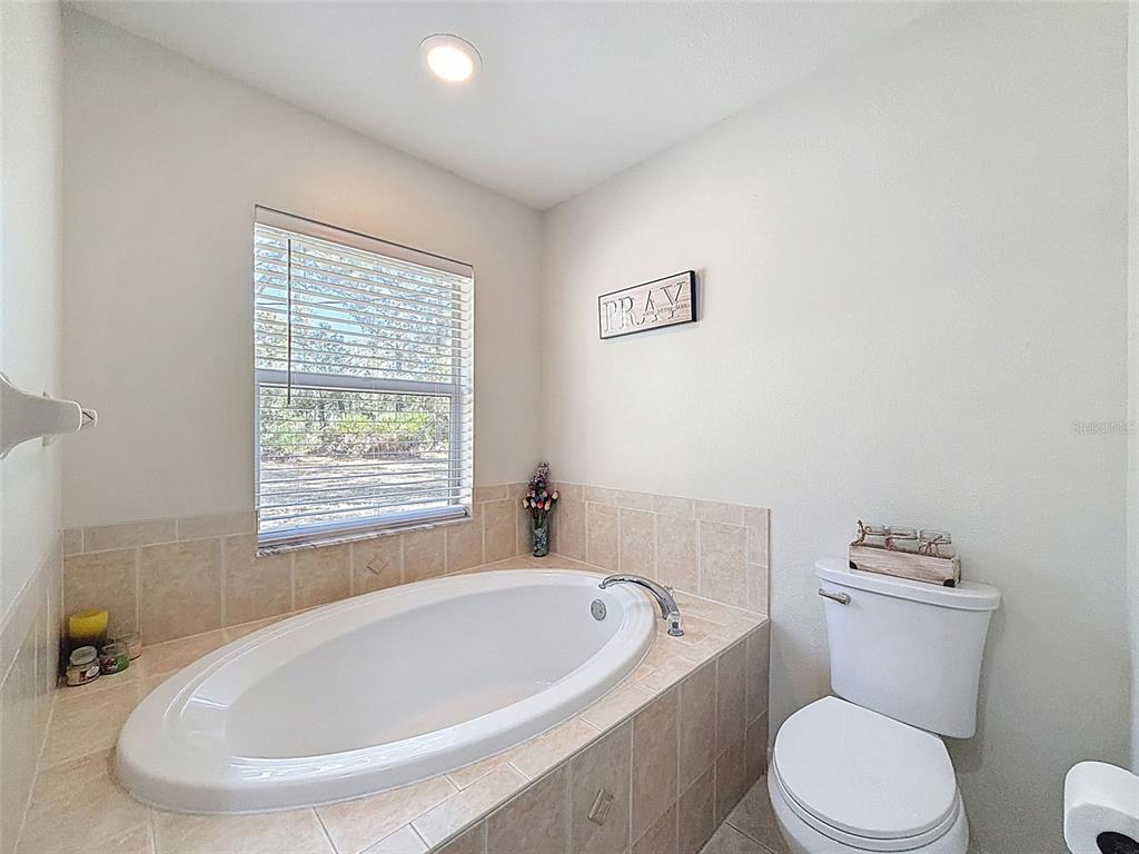 12105 Maripoe Road Weeki Wachee, FL 34614 - Photo 34 of 62 a white bath tub sitting next to a white toilet