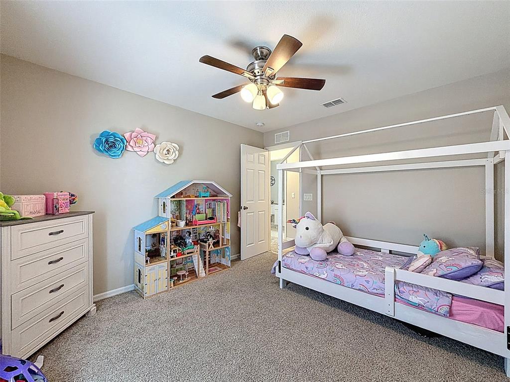 12105 Maripoe Road Weeki Wachee, FL 34614 - Photo 37 of 62 a bedroom with furniture and a fan