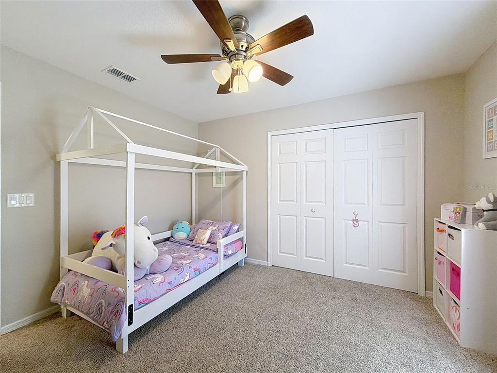 12105 Maripoe Road Weeki Wachee, FL 34614 - Photo 38 of 62 a bedroom with bed and a ceiling fan