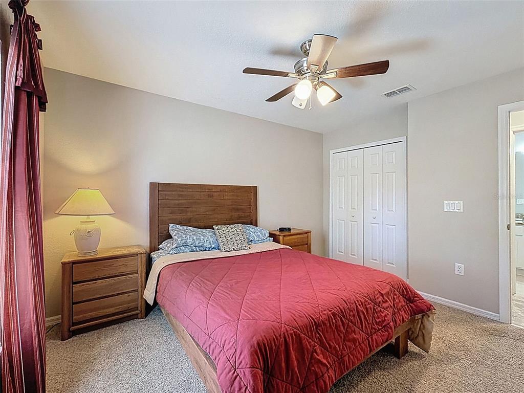 12105 Maripoe Road Weeki Wachee, FL 34614 - Photo 42 of 62 a bedroom with a bed and a chandelier